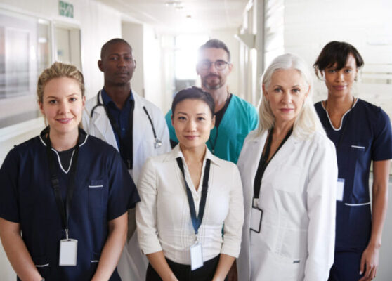 Portrait Of Medical Team Standing In Hospital Corridor