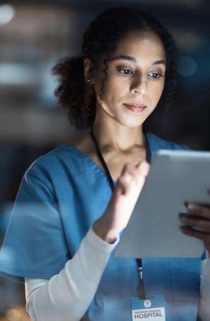 Medical tablet, nurse and black woman in hospital working late on telehealth, research or online co.